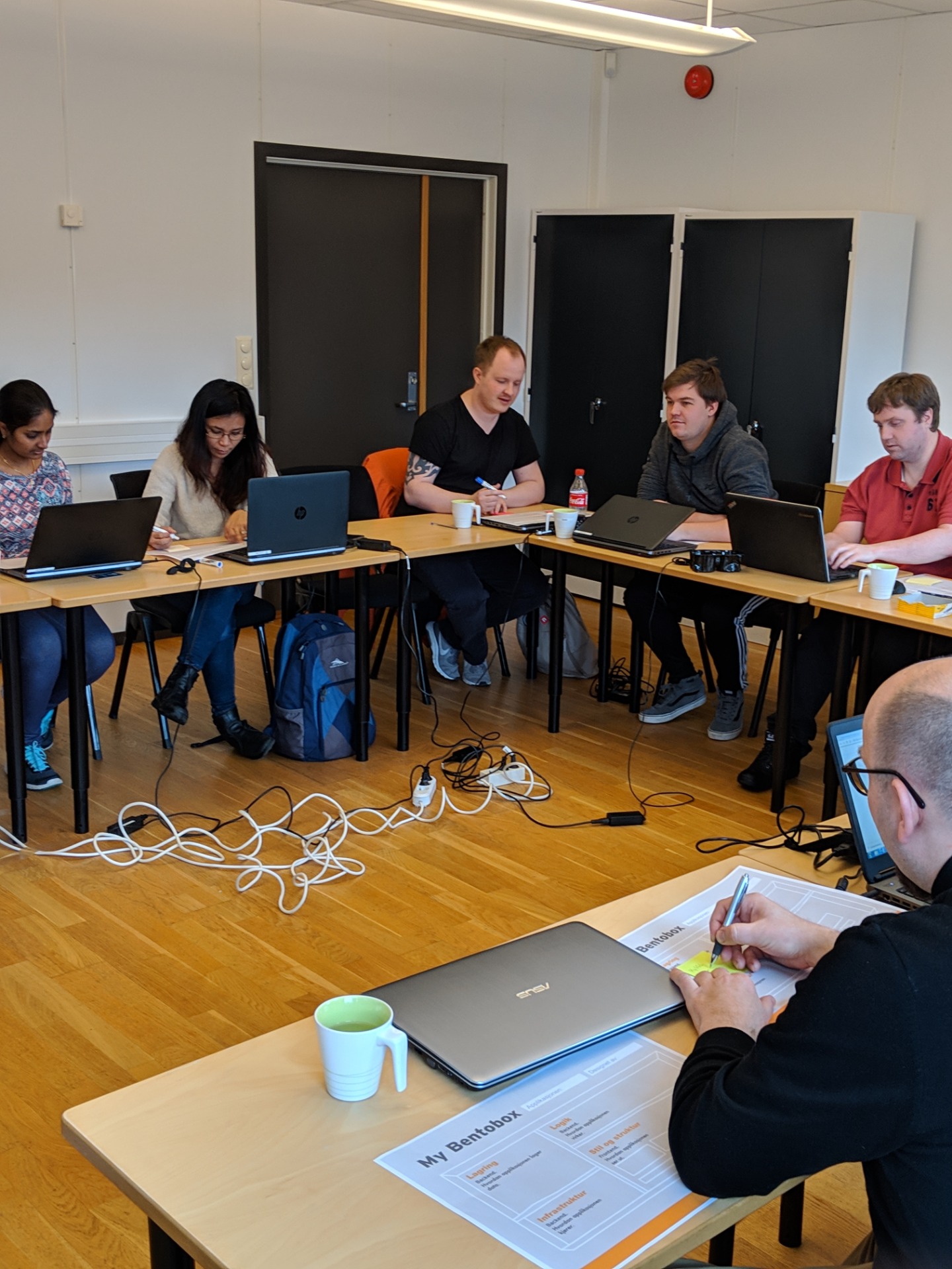 A flexible classroom arrangement allows for easier collaboration, pair programming and peer sharing of work. Yes, the cords became an issue. We were able to take this safety concern to administration and get a permanent standing bar installed in the middle that allowed us to easily reconfigure the desks.